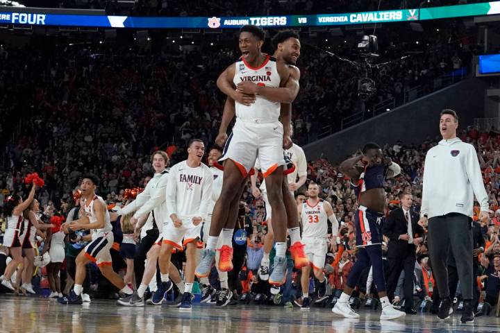 Virginia players celebrate after defeating Auburn 63-62 in the semifinals of the Final Four NCA ...