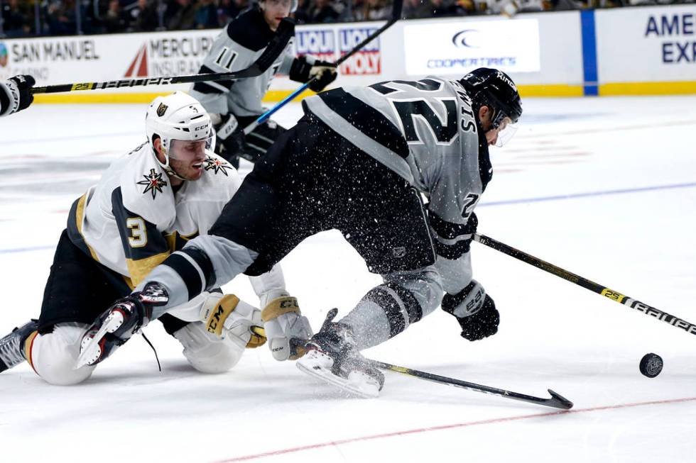 Los Angeles Kings forward Trevor Lewis (22) collides with Vegas Golden Knights defenseman Brayd ...