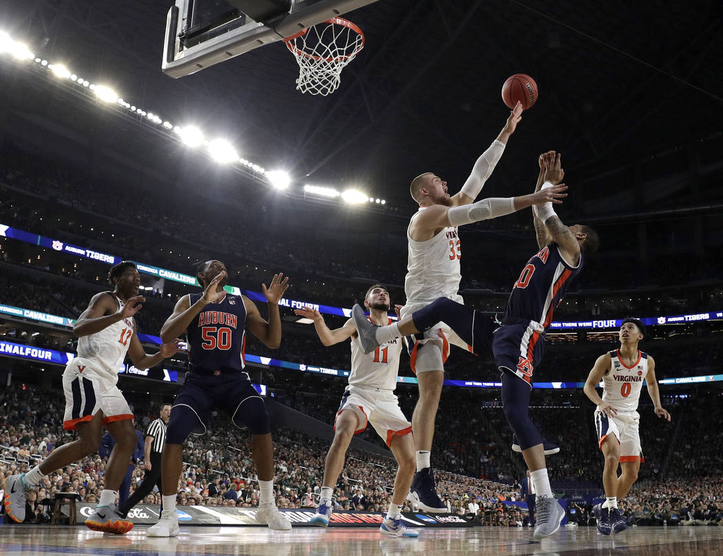 Virginia's Jack Salt (33) blocks a shot by Auburn's Samir Doughty (10) during the first half in ...