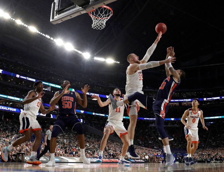 Virginia's Jack Salt (33) blocks a shot by Auburn's Samir Doughty (10) during the first half in ...