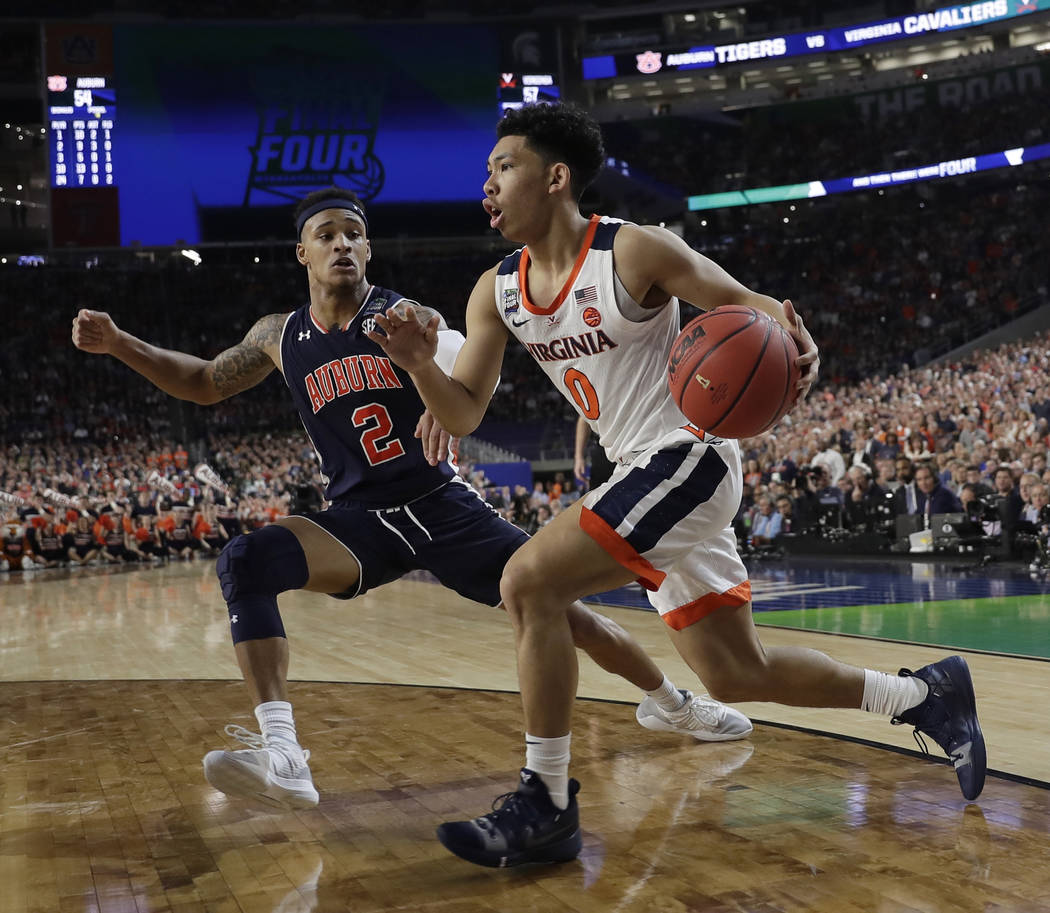 Virginia's Kihei Clark (0) drives against Auburn's Bryce Brown (2) during the second half in th ...