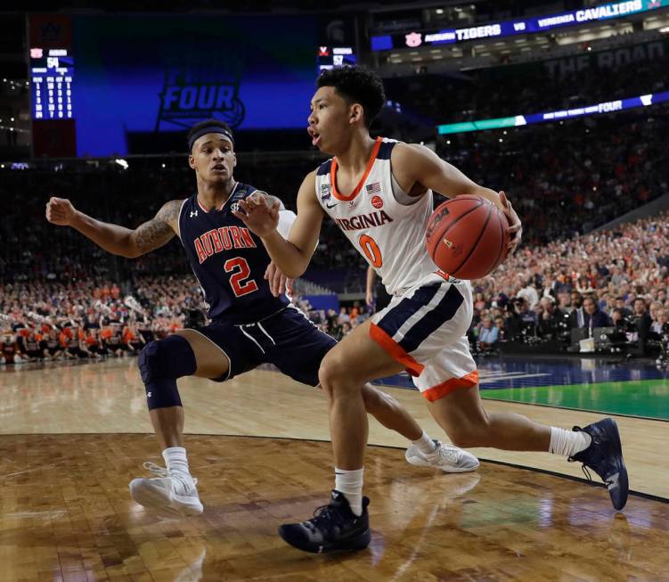 Virginia's Kihei Clark (0) drives against Auburn's Bryce Brown (2) during the second half in th ...