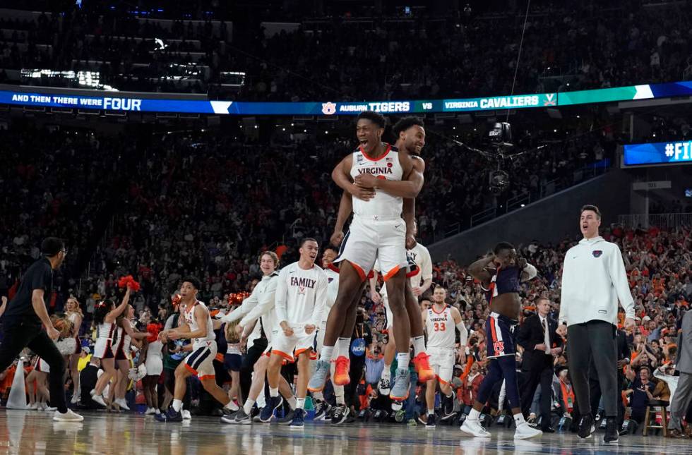 Virginia players celebrate after defeating Auburn 63-62 in the semifinals of the Final Four NCA ...