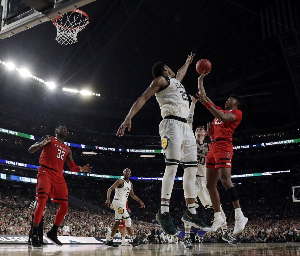 Texas Tech's Jarrett Culver (23) takes a shot against Michigan State's Xavier Tillman (23) and ...