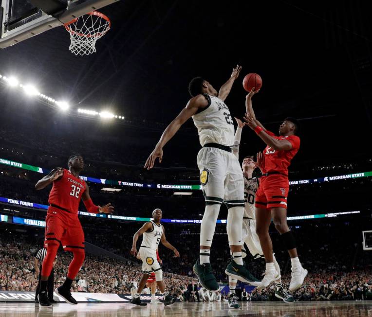 Texas Tech's Jarrett Culver (23) takes a shot against Michigan State's Xavier Tillman (23) and ...