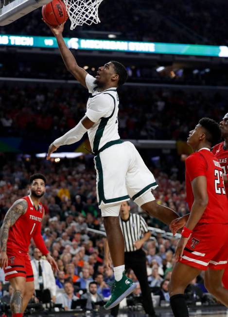 Michigan State's Aaron Henry (11) goes up for a basket during the second half in the semifinals ...