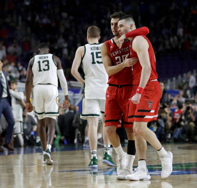 Texas Tech's Davide Moretti (25) and Matt Mooney celebrate after defeating Michigan State 61-51 ...