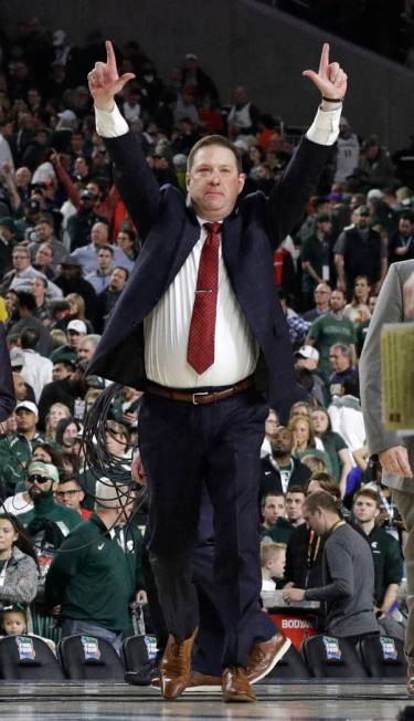 Texas Tech head coach Chris Beard celebrates at the end of a semifinal round game against Michi ...