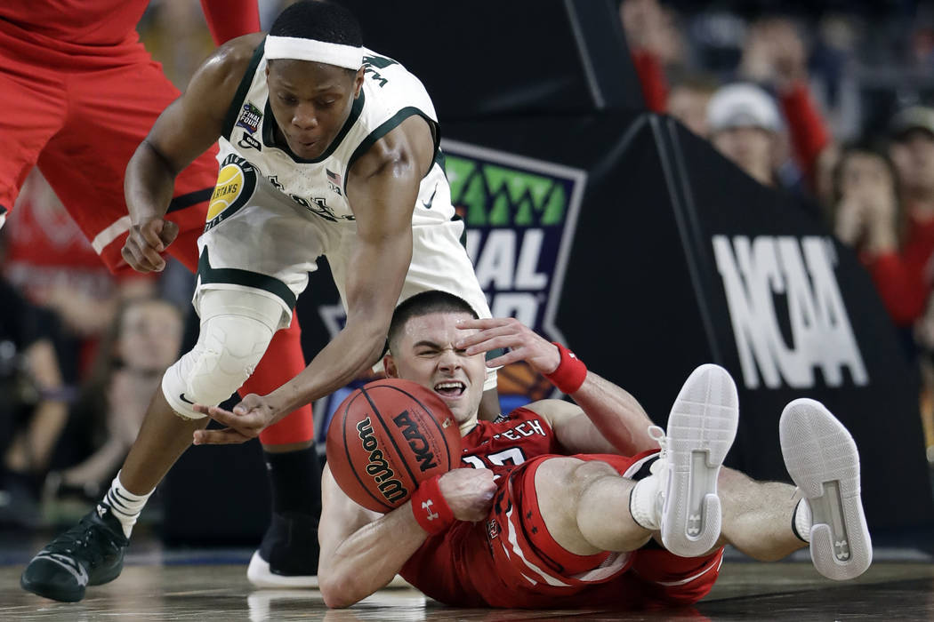 Texas Tech's Matt Mooney (13) battles for a loose ball against Michigan State's Cassius Winston ...