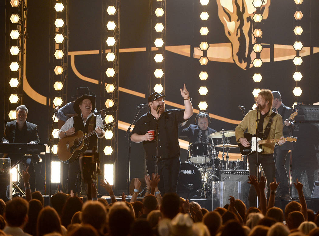 Kix Brooks, left, and Ronnie Dunn, right, of Brooks & Dunn, and Luke Combs perform "Br ...