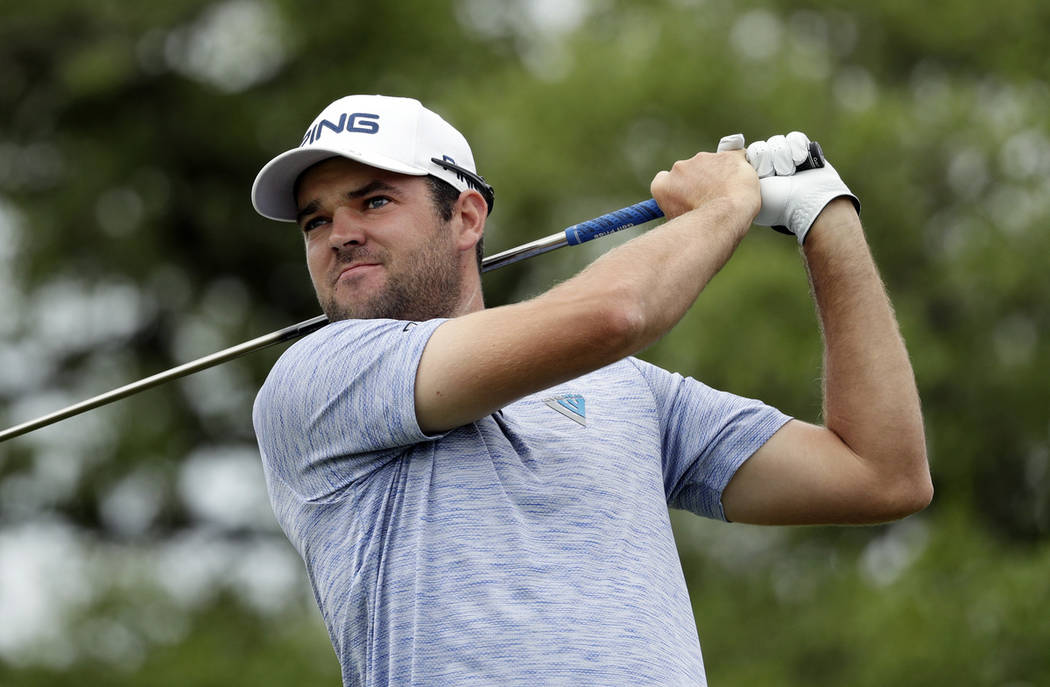 Corey Conners watches his drive on the second hole during the final round of the Texas Open gol ...