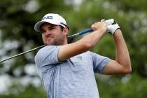 Corey Conners watches his drive on the second hole during the final round of the Texas Open gol ...