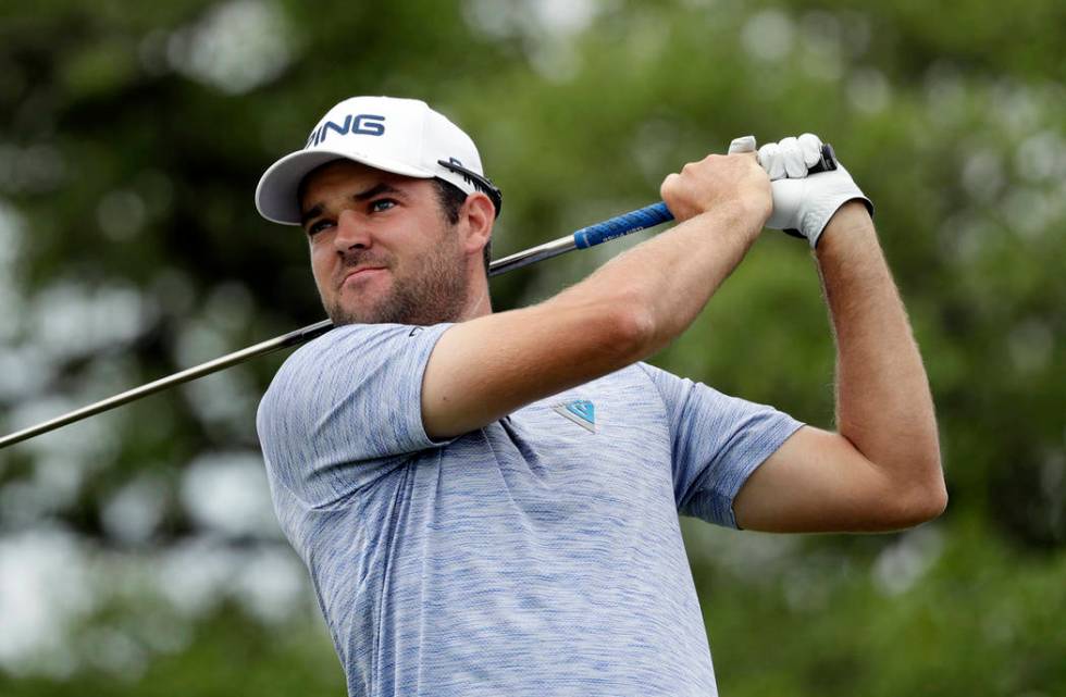 Corey Conners watches his drive on the second hole during the final round of the Texas Open gol ...