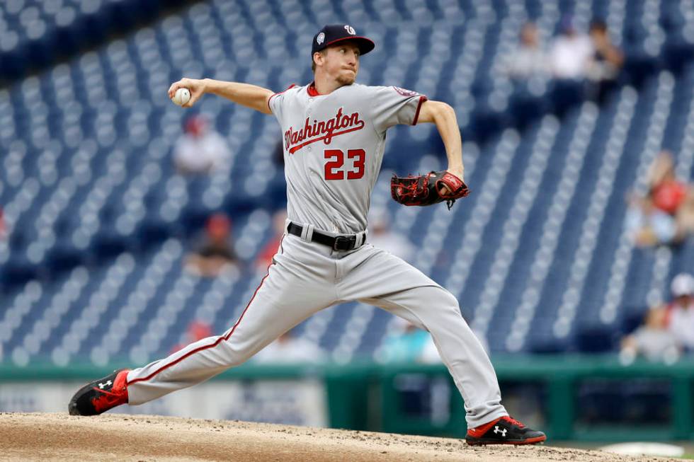 Washington Nationals' Erick Fedde pitches during the third inning of the first game of a baseba ...