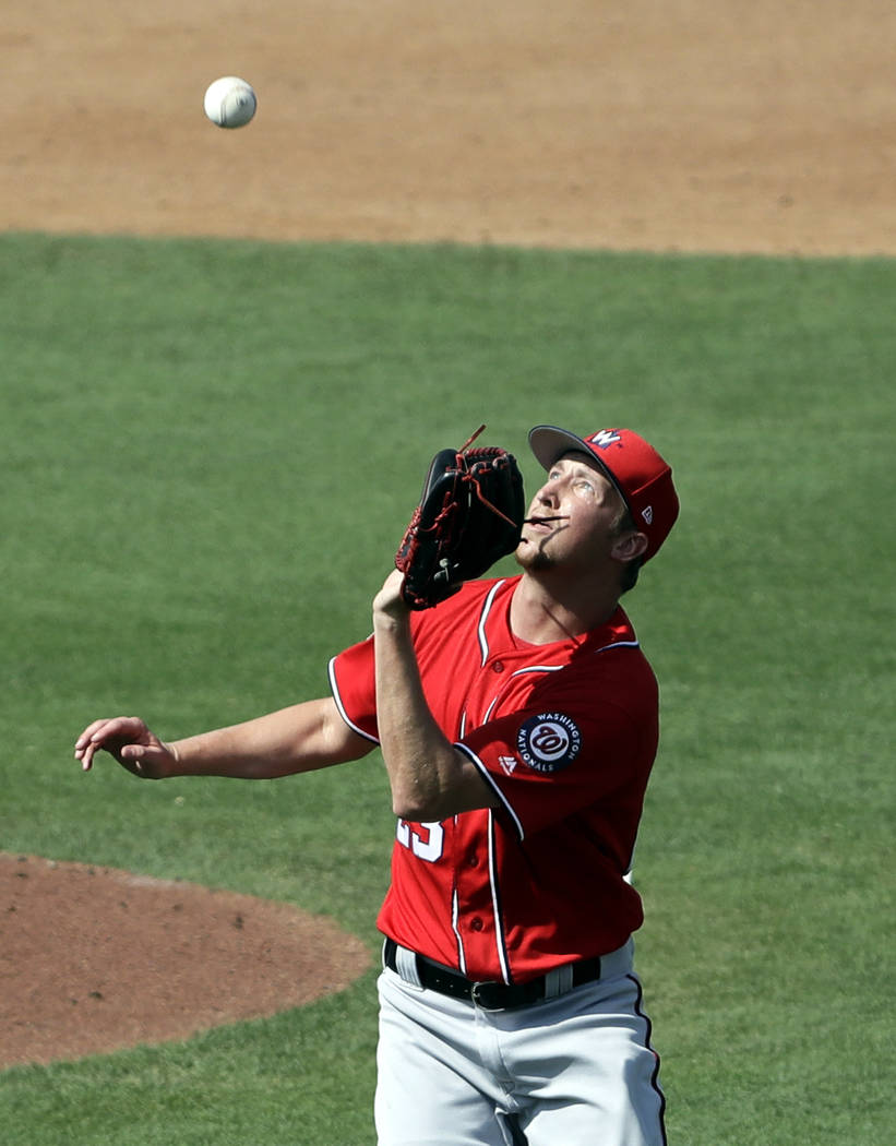 Washington Nationals pitcher Erick Fedde keeps his eye on a ball hit by Miami Marlins' JT Riddl ...