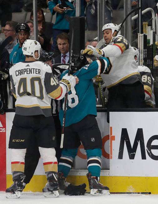 San Jose Sharks center Micheal Haley, center, goes after Vegas Golden Knights right wing Ryan R ...