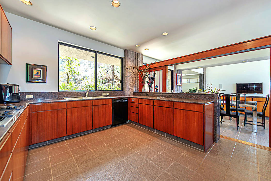 The kitchen features teak cabinetry. (Luxury Estates International)