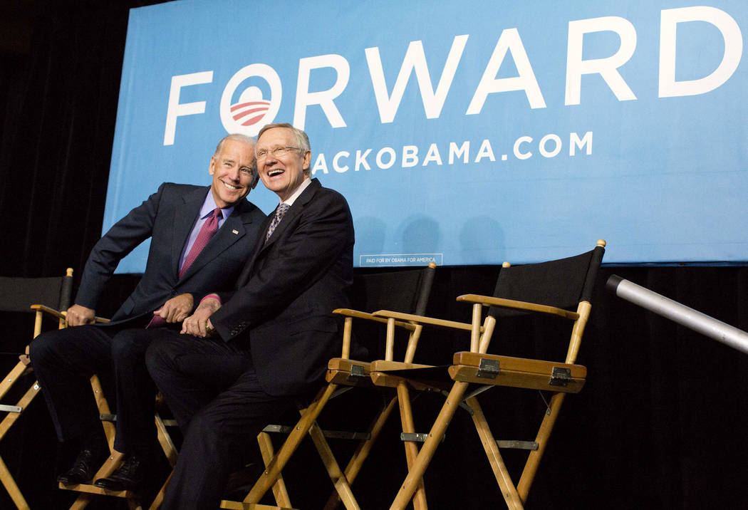 Vice president Joe Biden, left, and Senate Majority Leader Harry Reid of Nev. react to cheers f ...