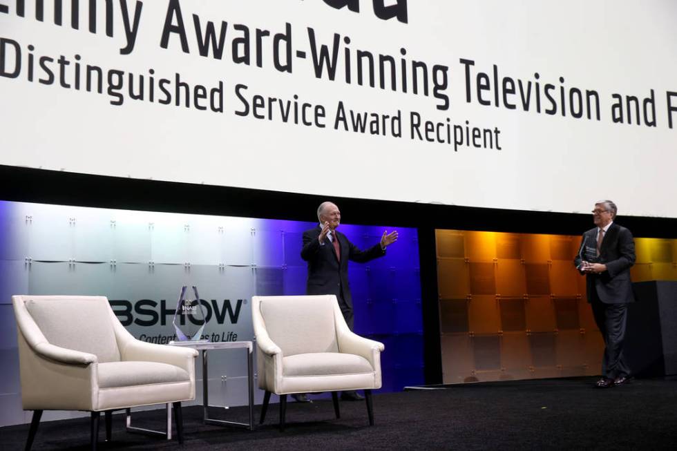 Actor, director, screenwriter and podcaster Alan Alda walks on stage to receive the Distinguish ...