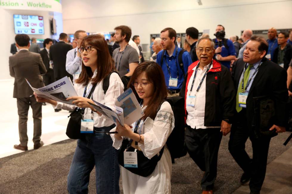 Conventioneers pour onto the show floor on the opening day of the National Association of Broad ...