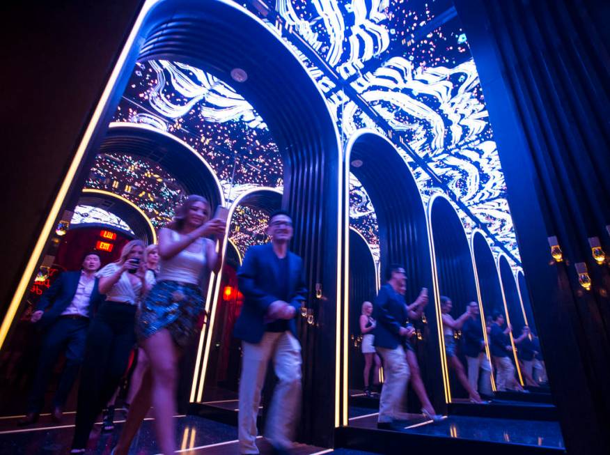 Attendees walk through a mirrored hallway to enter Kaos, the new dayclub and nightclub at the P ...