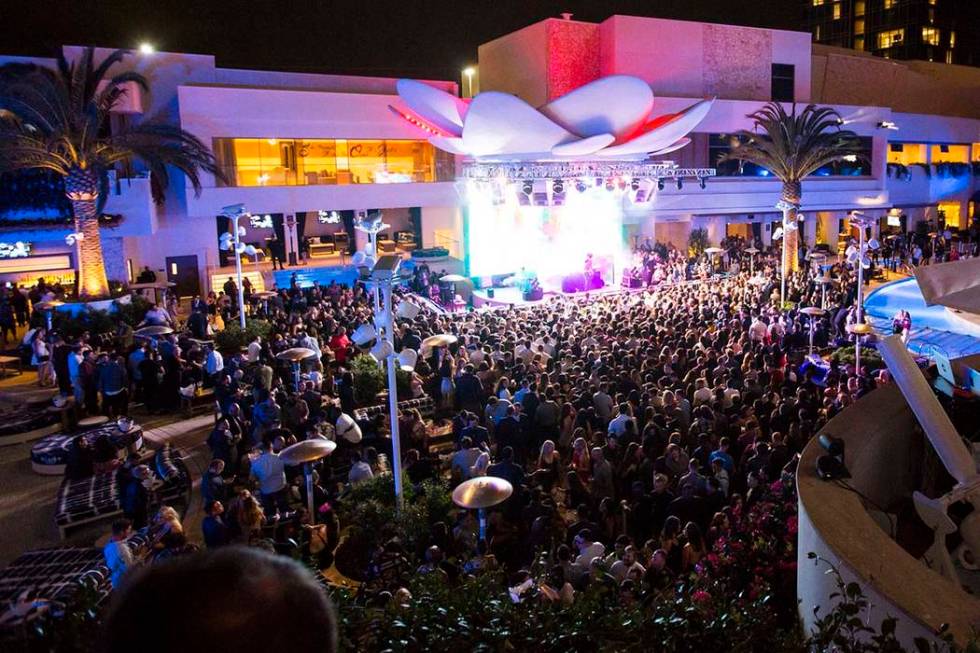 Attendees dance to Saint Jhn around the outdoor area the during the grand opening weekend of Ka ...