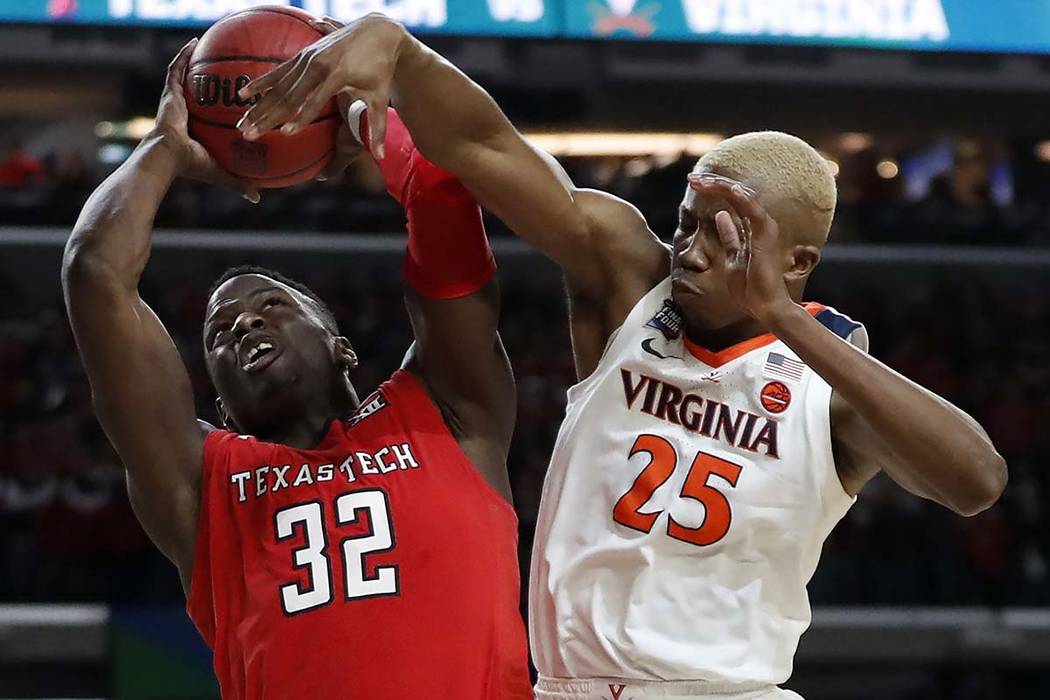 Texas Tech's Norense Odiase (32) shoots against Virginia's Mamadi Diakite (25) during the secon ...