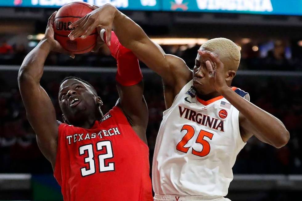 Texas Tech's Norense Odiase (32) shoots against Virginia's Mamadi Diakite (25) during the secon ...