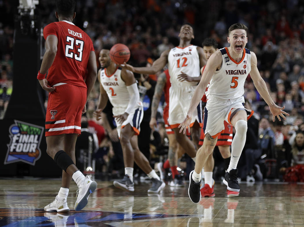 Virginia guard Kyle Guy (5) celebrates in front of Texas Tech guard Jarrett Culver (23) at the ...