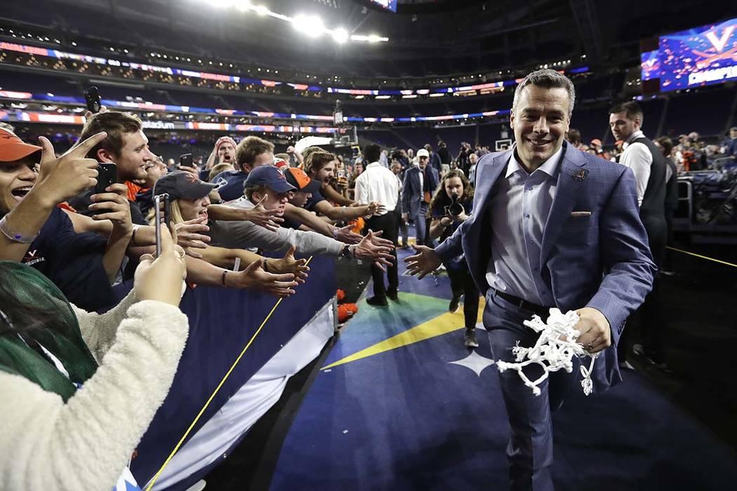 Virginia head coach Tony Bennett celebrates with fans after the championship game against Texas ...