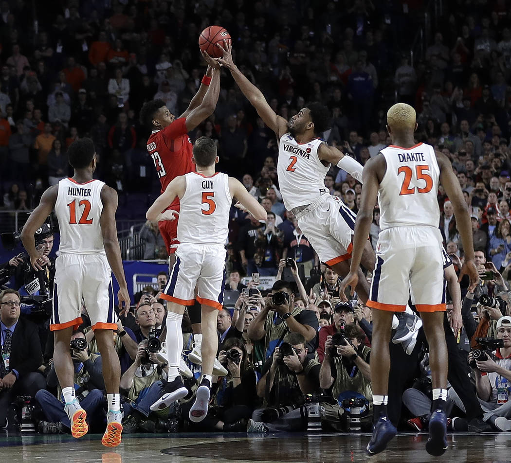 Virginia's Braxton Key (2) blocks a shot by Texas Tech's Jarrett Culver (23) during the second ...