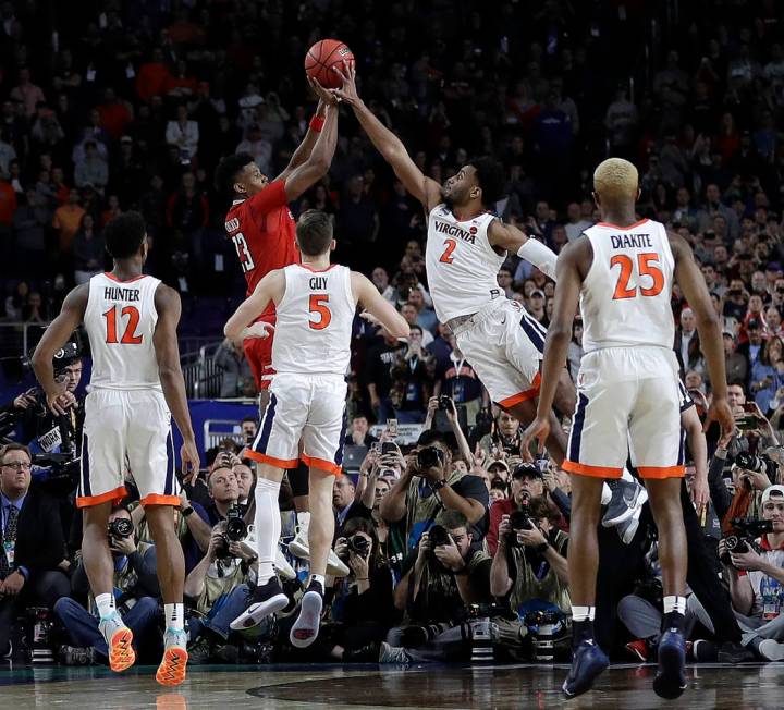 Virginia's Braxton Key (2) blocks a shot by Texas Tech's Jarrett Culver (23) during the second ...