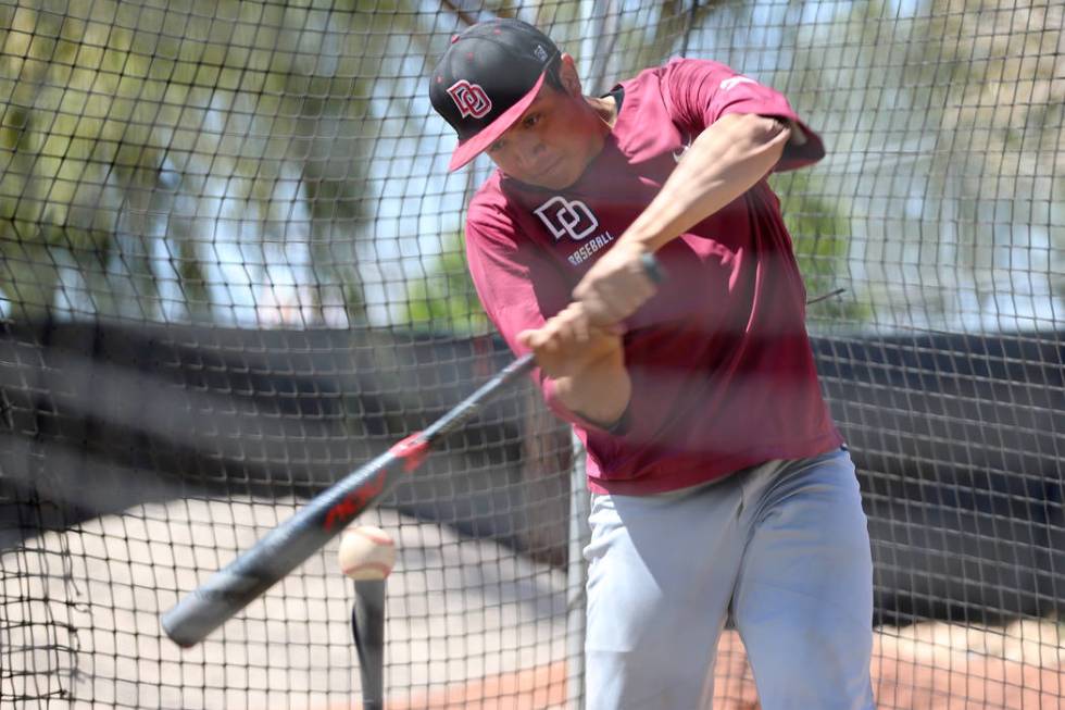 Desert Oasis senior Aaron Roberts, 18, hits the ball during a team practice at Desert Oasis Hig ...