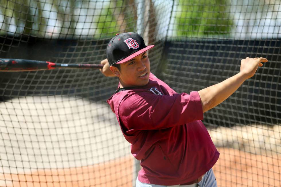 Desert Oasis senior Aaron Roberts, 18, hits the ball during a team practice at Desert Oasis Hig ...