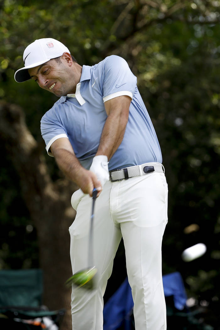 Francesco Molinari, of Italy, watches his tee shot on the second hole during a practice round f ...