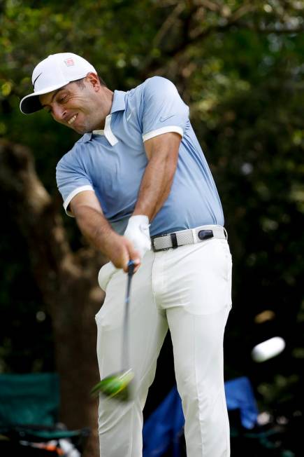 Francesco Molinari, of Italy, watches his tee shot on the second hole during a practice round f ...