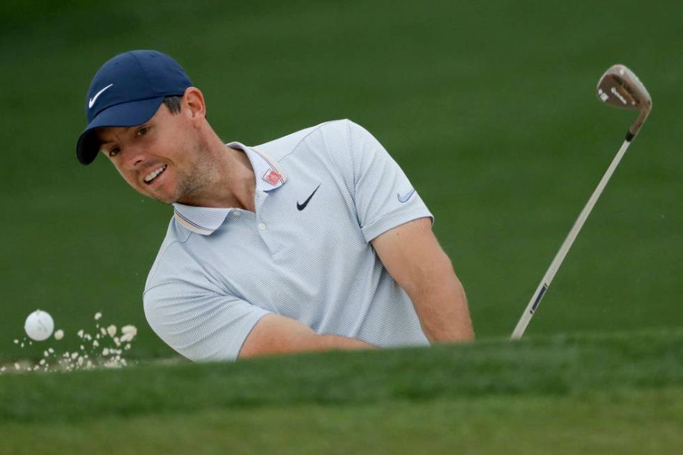 Rory McIlroy, of Northern Ireland, hits out of the bunker on the second hole during a practice ...