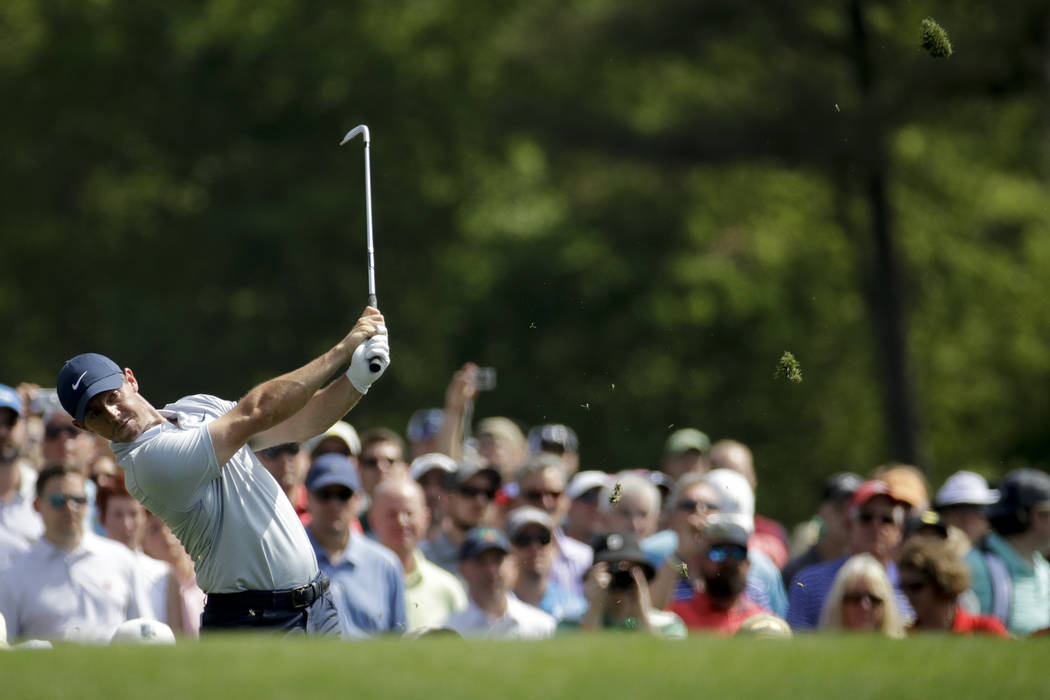 Rory McIlroy, of Northern Ireland, watches his tee shot on the 12th hole during a practice roun ...