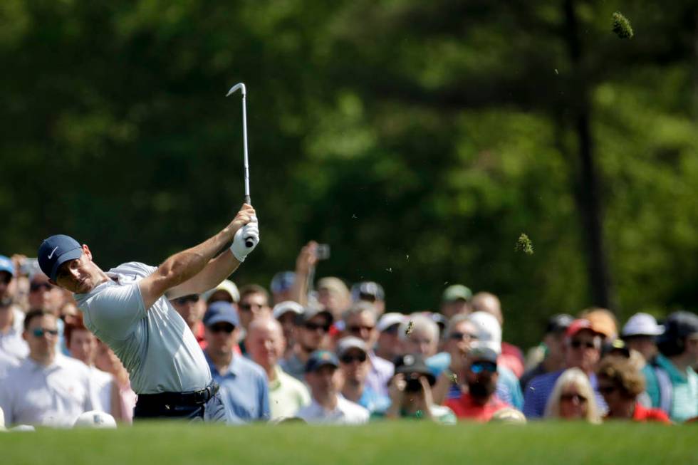 Rory McIlroy, of Northern Ireland, watches his tee shot on the 12th hole during a practice roun ...