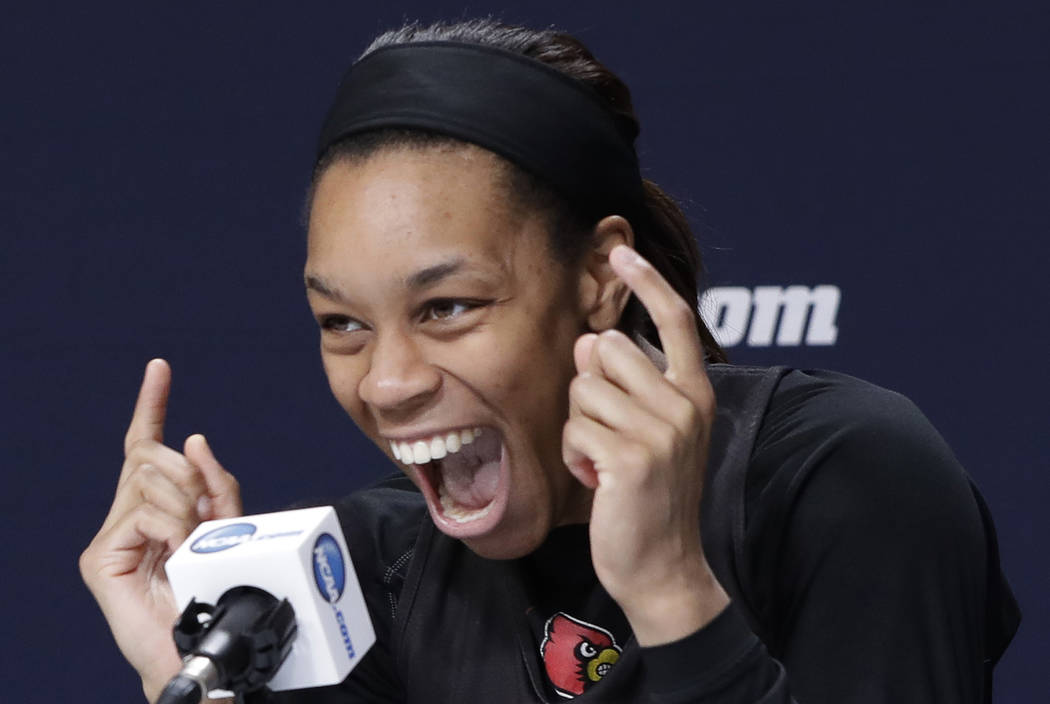 Louisville guard Asia Durr laughs as she tells a joke during a news conference at the NCAA wome ...