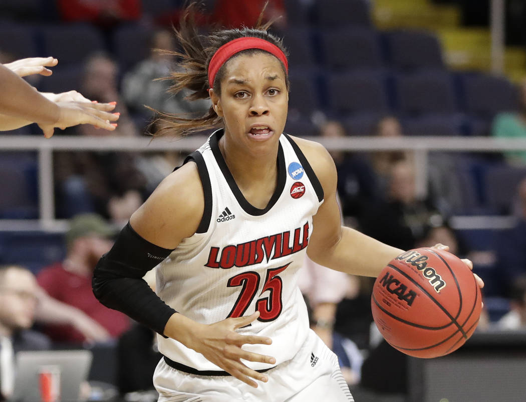 Louisville guard Asia Durr (25) drives trhough traffic during the second half of a regional sem ...