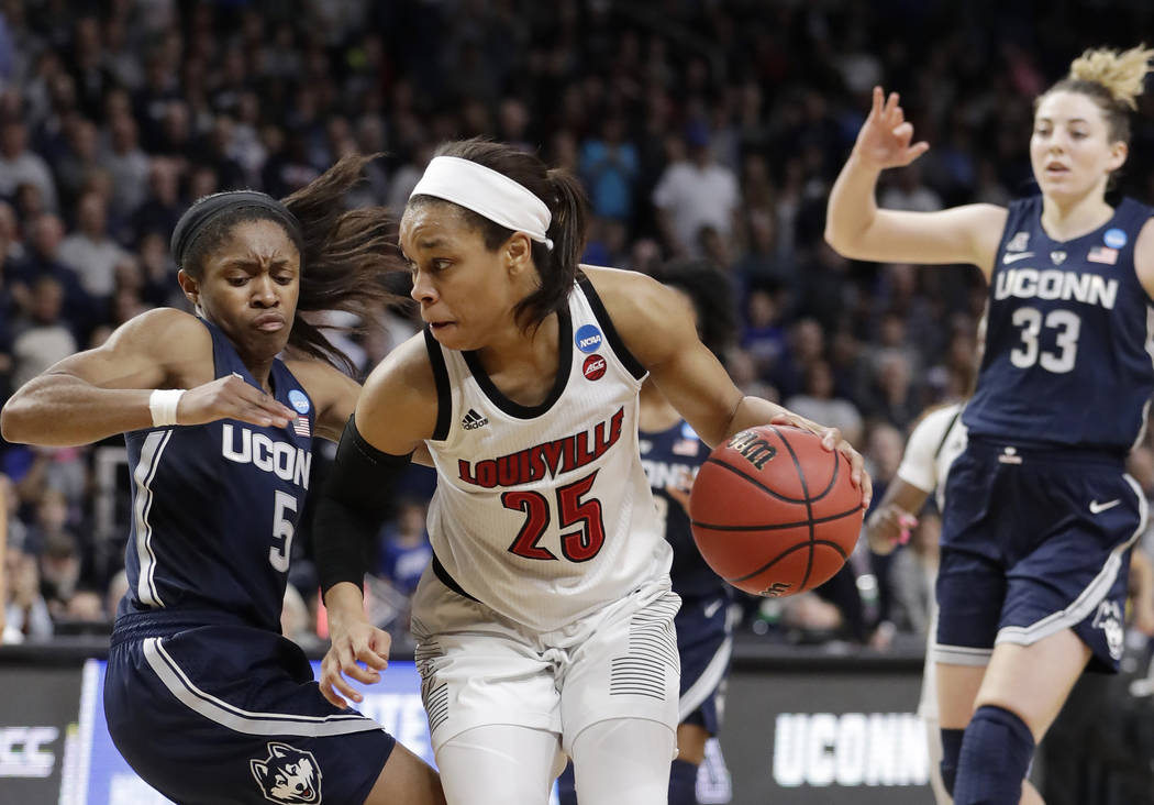 Connecticut guard Crystal Dangerfield (5) defends against Louisville guard Asia Durr (25) as Co ...