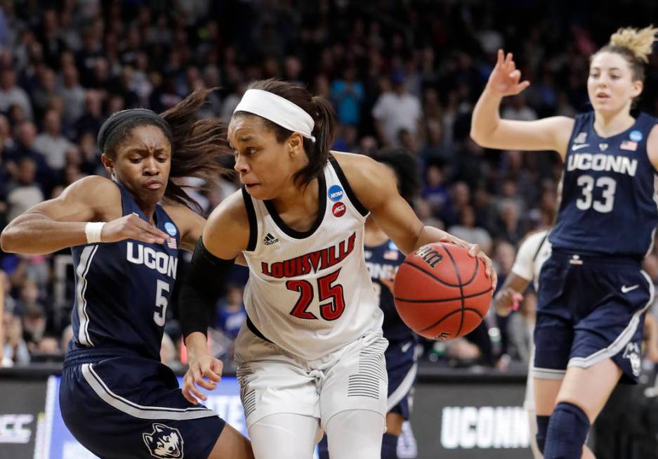 Connecticut guard Crystal Dangerfield (5) defends against Louisville guard Asia Durr (25) as Co ...