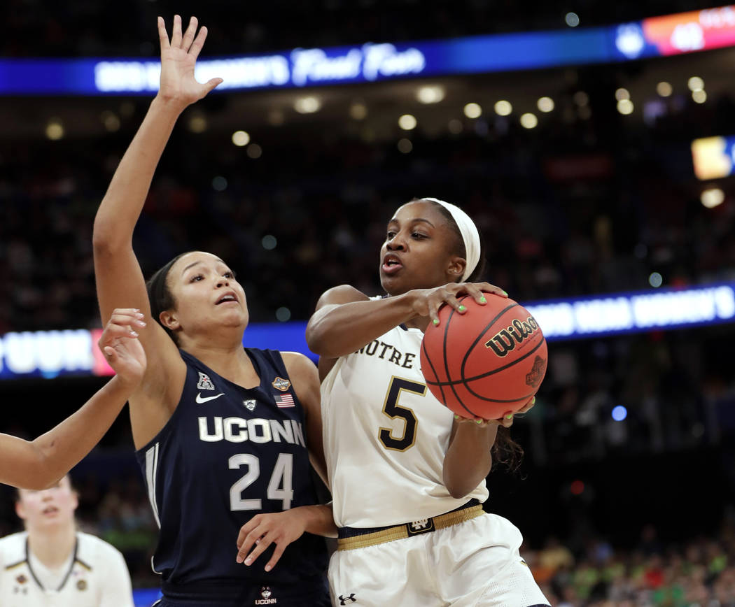 Notre Dame guard Jackie Young (5) drives to the basket as Connecticut forward Napheesa Collier ...