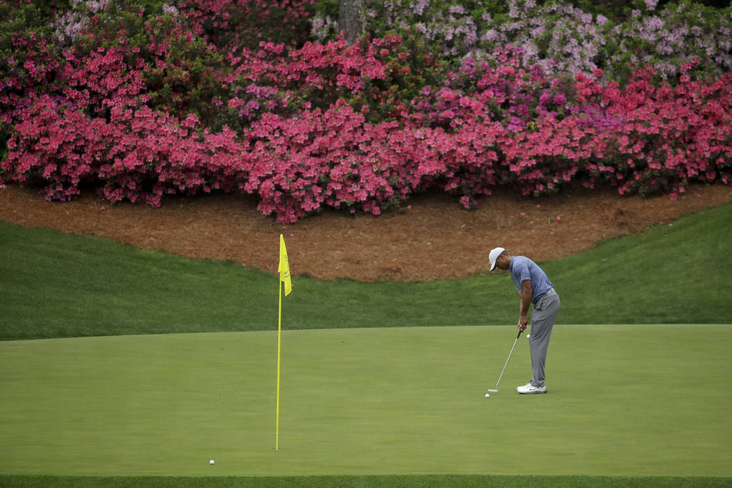 Tiger Woods putts on the 13th hole during a practice round for the Masters golf tournament Mond ...