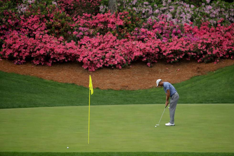 Tiger Woods putts on the 13th hole during a practice round for the Masters golf tournament Mond ...