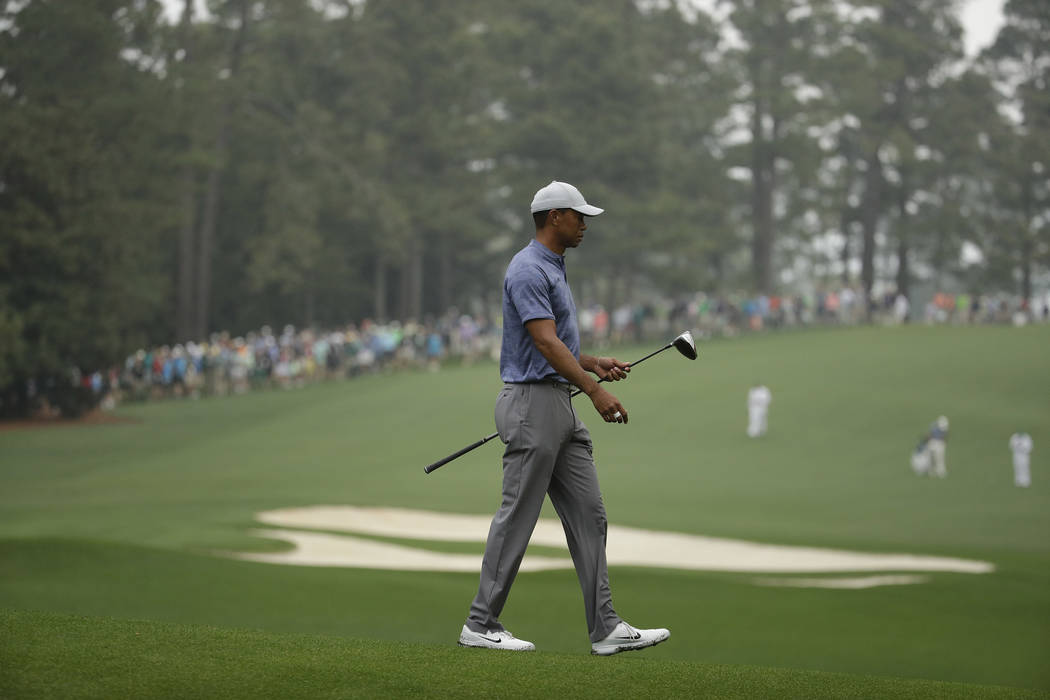 Tiger Woods walks off the 11th tee during a practice round for the Masters golf tournament Mond ...