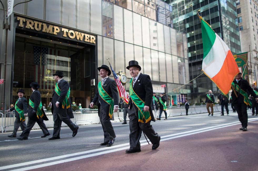 Participants march up Fifth Avenue past Trump tower during the St. Patrick's Day Parade, Saturd ...