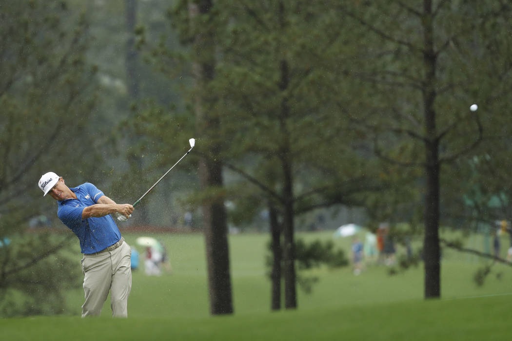 Charley Hoffman hits from the fairway in the rain on the first hole during a practice round for ...