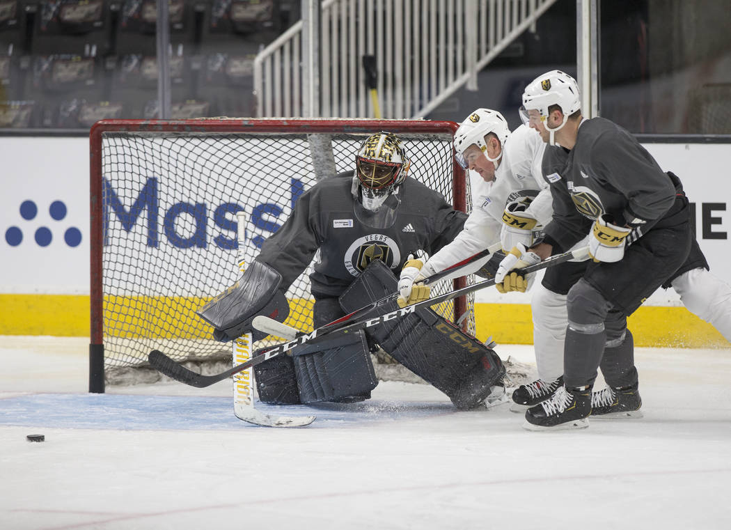 Golden Knights goaltender Malcolm Subban (30) makes a save against center Ryan Carpenter (40) w ...